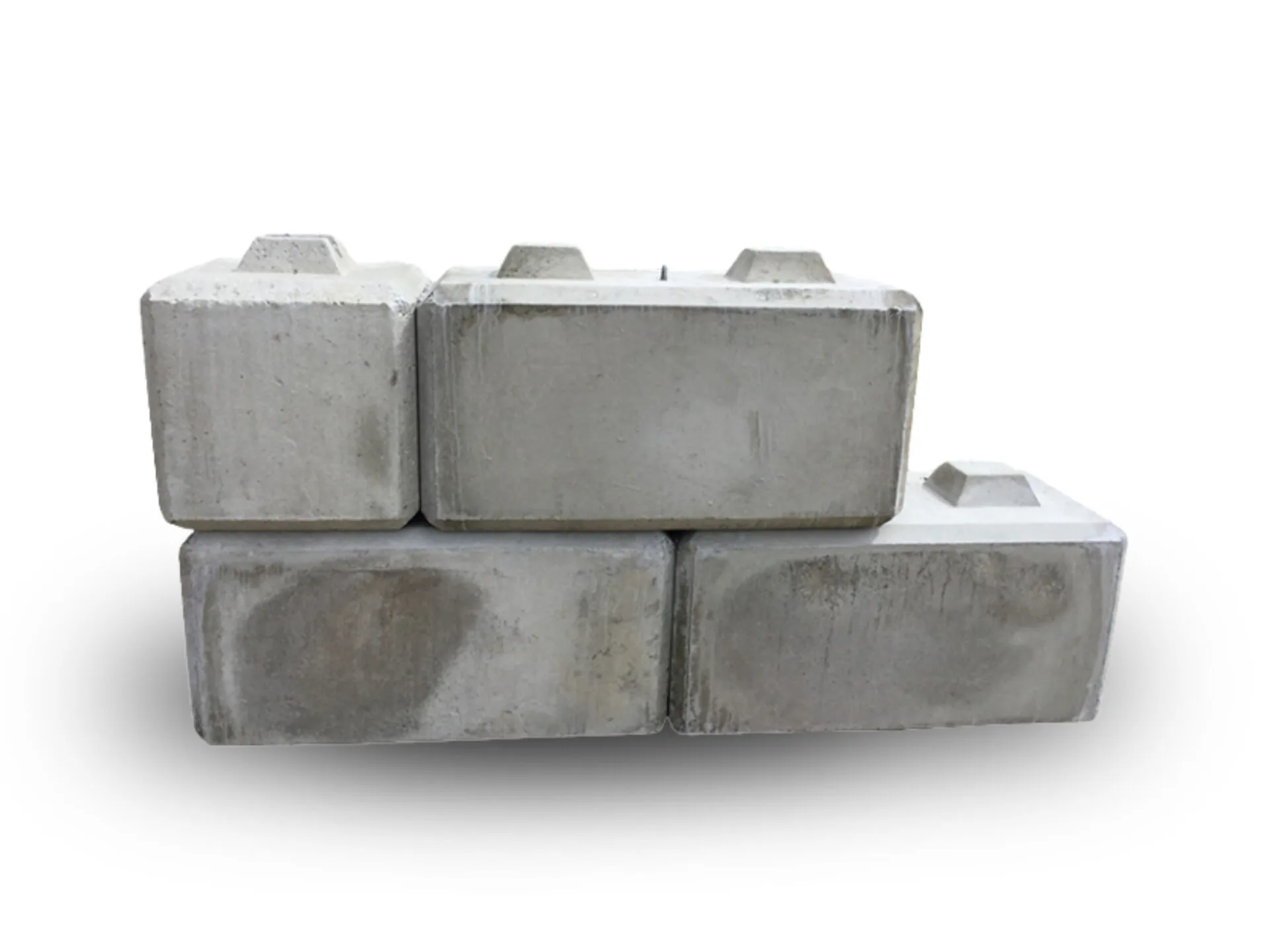 Stack of six gray concrete blocks arranged on a white background, showing texture and rectangular shapes.