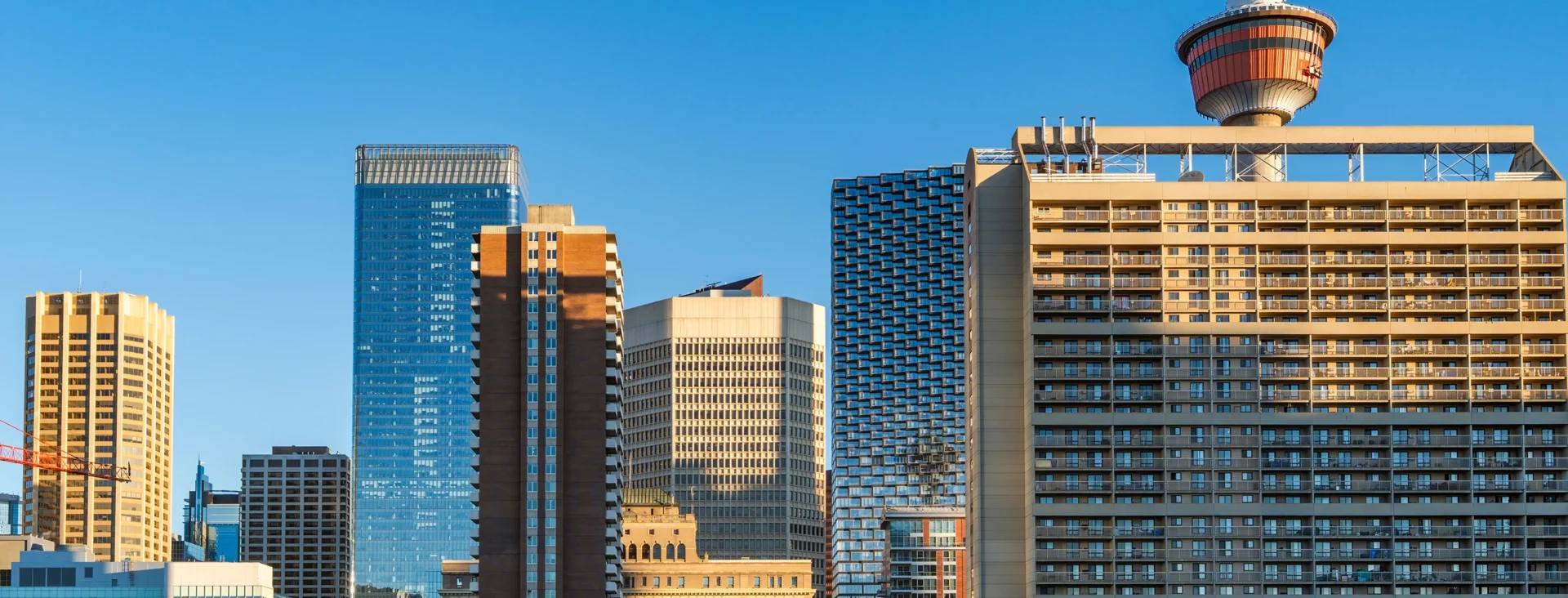 City skyline featuring modern high-rise buildings under a clear blue sky during daytime.