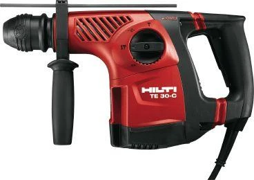 Red and black Hilti TE 30-C rotary hammer drill with side handle and power cord isolated on white background.