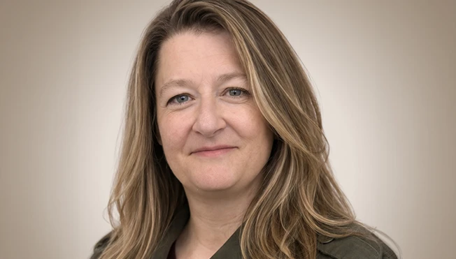 Portrait of Mira Gentile against a neutral background.
