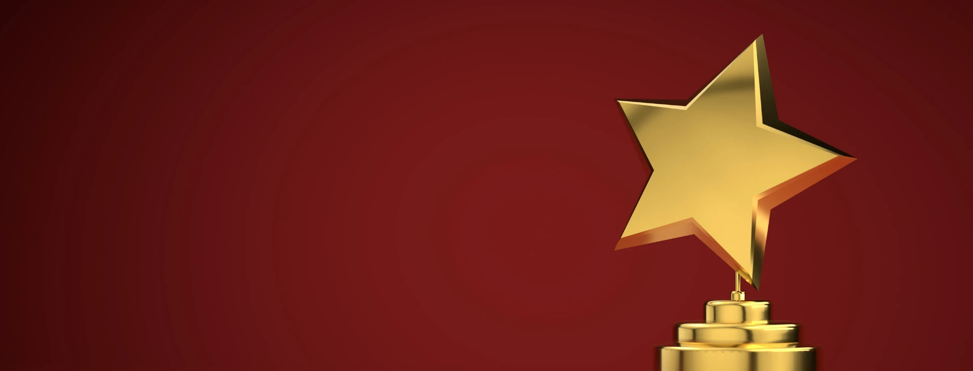 Gold star trophy on a red background, symbolizing achievement and success.